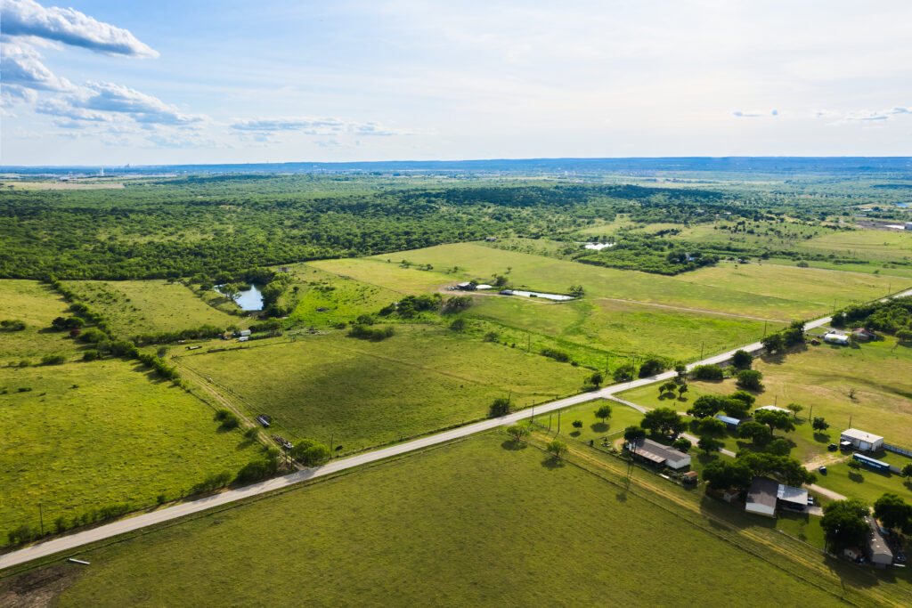 An aerial view of a Mayfair homes farm and countryside in New Braunfels, Texas.