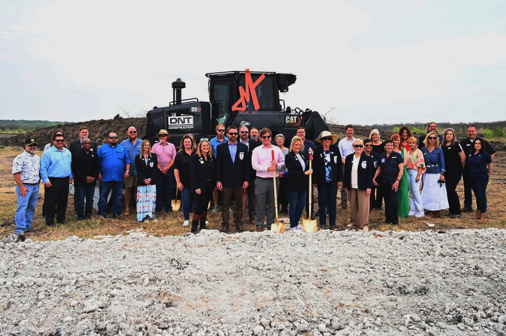 A group of people standing in front of a train in Mayfair homes, New Braunfels.