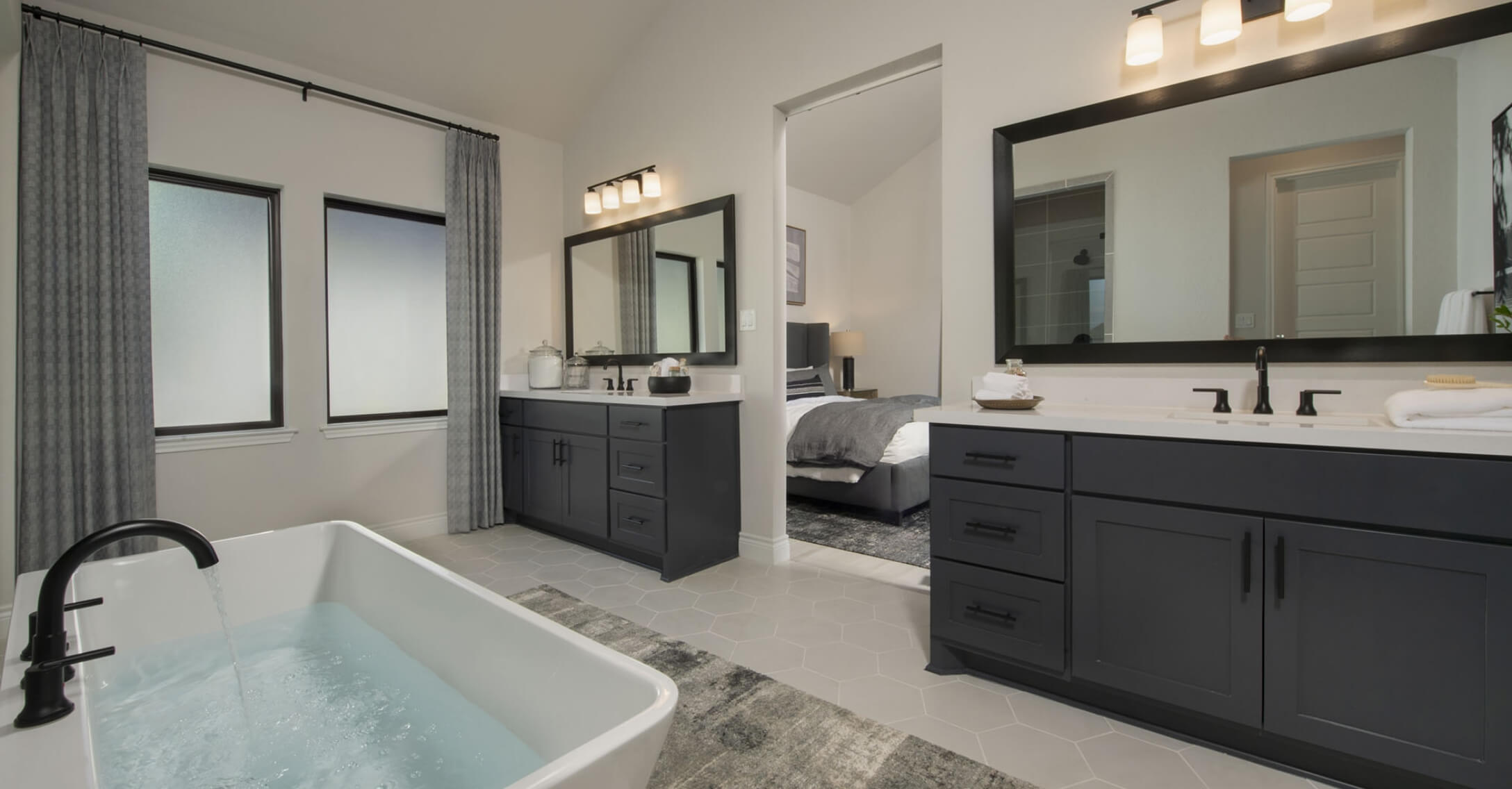 A Mayfair home in New Braunfels featuring a bathroom with dual sinks and a bathtub.