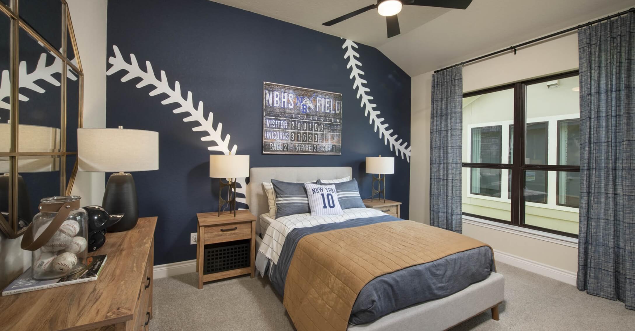 A baseball themed bedroom with blue walls in a Mayfair home.