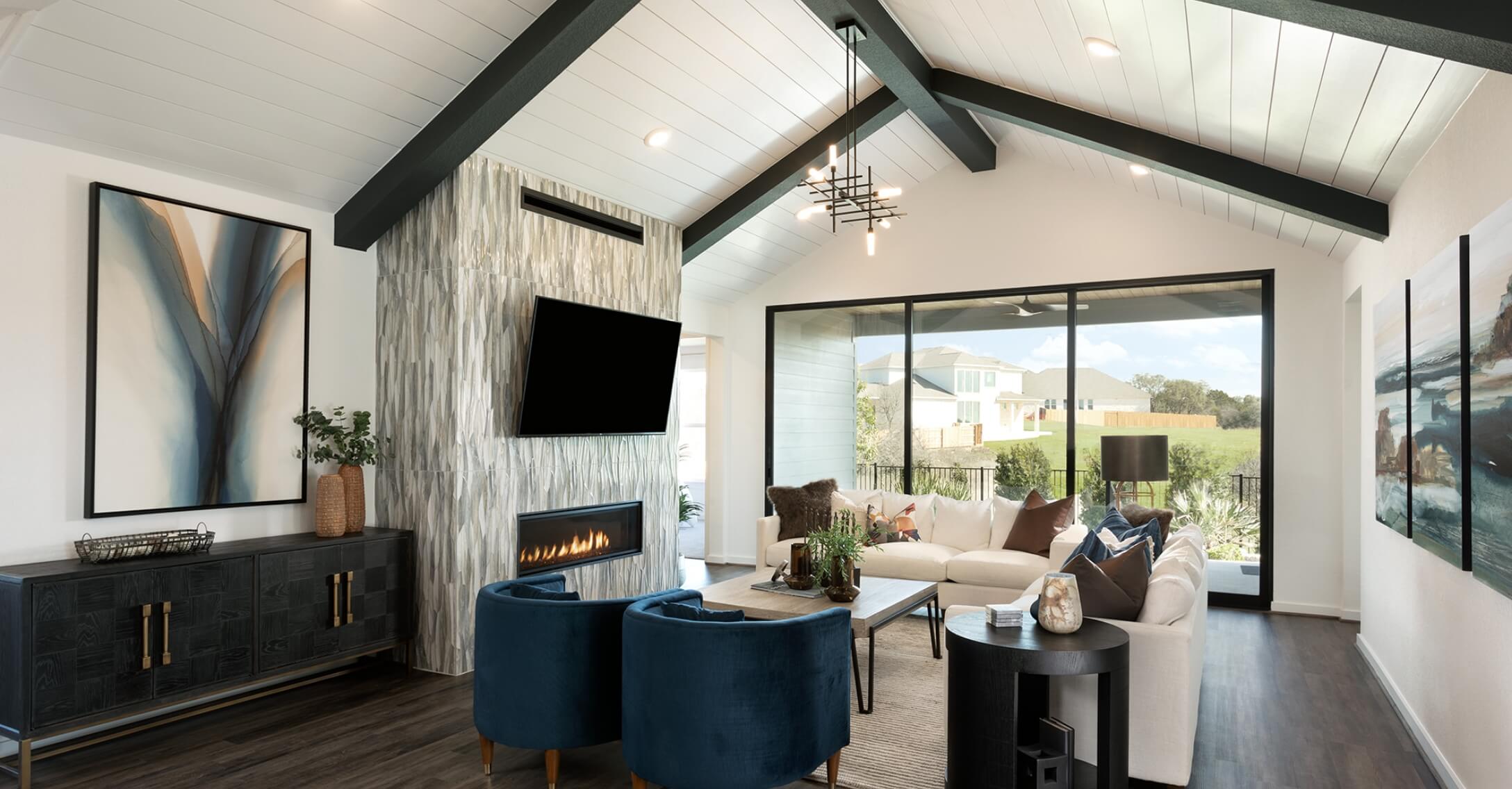 A living room with vaulted ceilings and a fireplace in new homes New Braunfels Texas.
