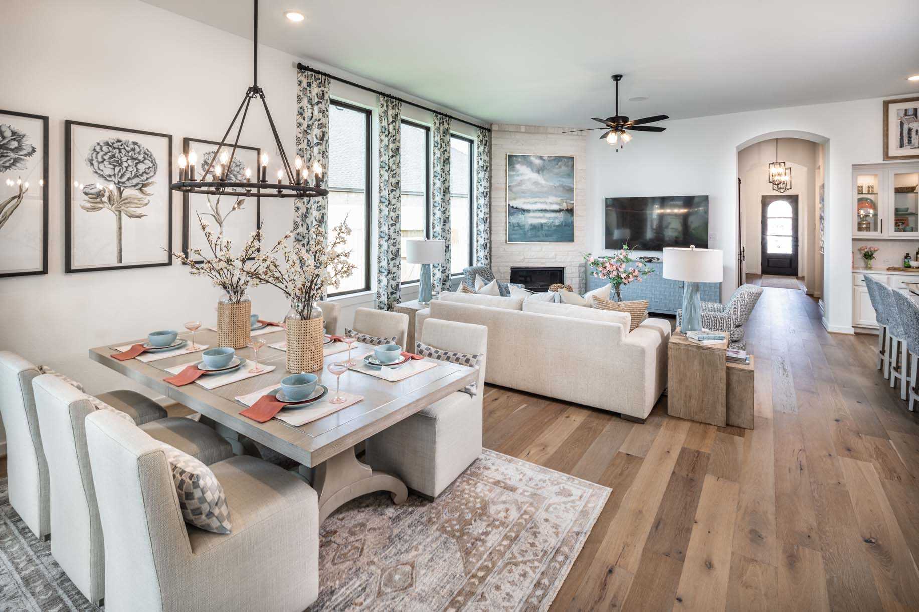 A modern Mayfair home with a spacious living room, dining area, and open kitchen in New Braunfels, Texas.