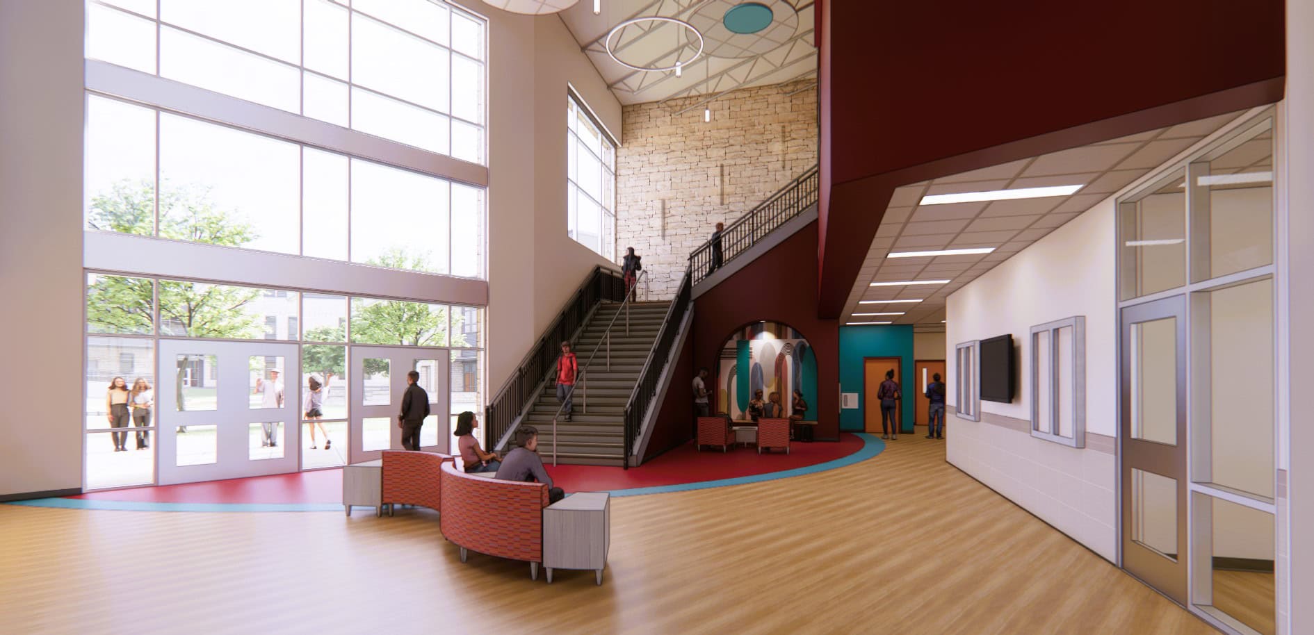 Spacious Major Middle School entrance with large windows, wood flooring, seating area, and people walking near a staircase leading to the upper level.