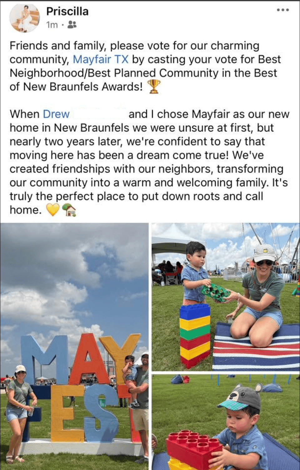 Two adults and two children play outdoors near large "MAYFAIR" letters and colorful blocks, participating in a community event under sunny skies.